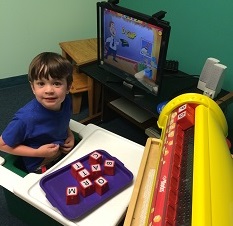 Photo of Rahul and Lekotek leader Jennifer playing with E-blocks