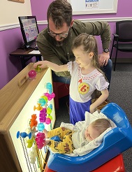 girl and Lekotek leader do a puzzle