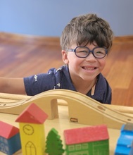 boy plays with train table