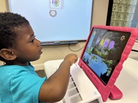 boy plays at rice table