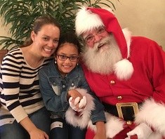 mom and daughter with Santa