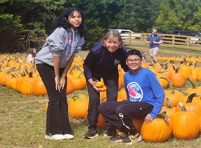 siblings enjoy pumpkins