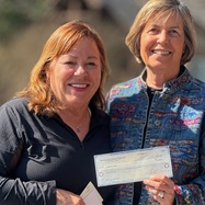 receiving a check from Charity Guild of the Country Club of the South.